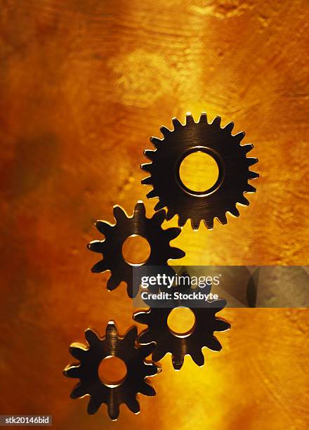 toned close-up of an array of gear wheels - four engine stock pictures, royalty-free photos & images