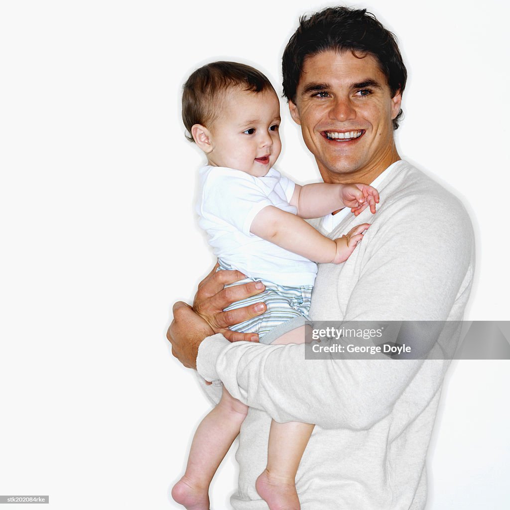 Father holding baby son (12-18 months)
