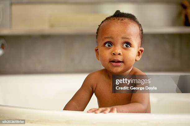 portrait of a baby (12-18 months) having a bath - only baby girls stock pictures, royalty-free photos & images