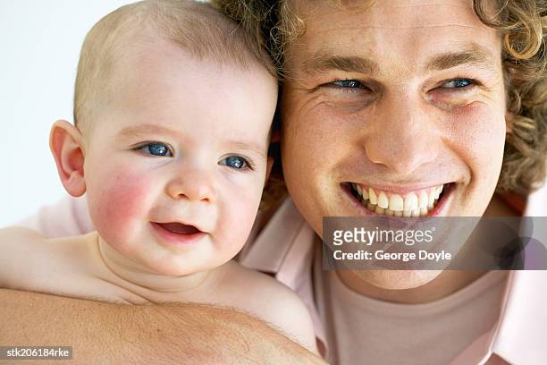 close up view of a father spending time with his baby (12-18 months) - genderblend stock-fotos und bilder