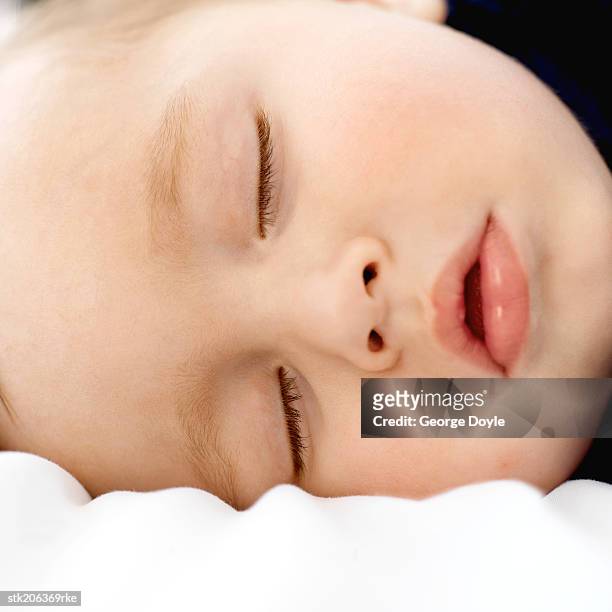 close up view of a baby (6-12 months) sleeping - only baby boys stock pictures, royalty-free photos & images