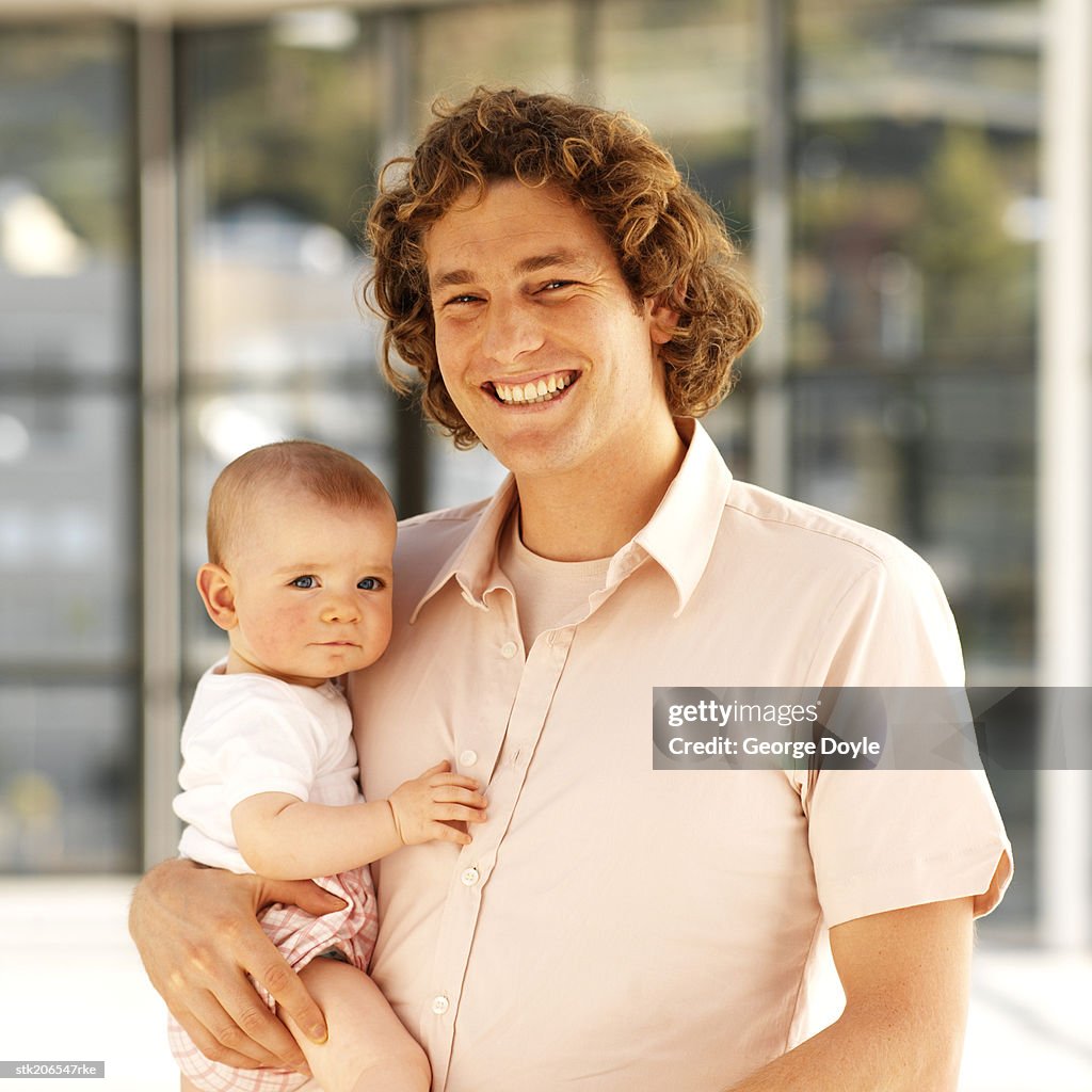 Father holding baby (6-12 months)