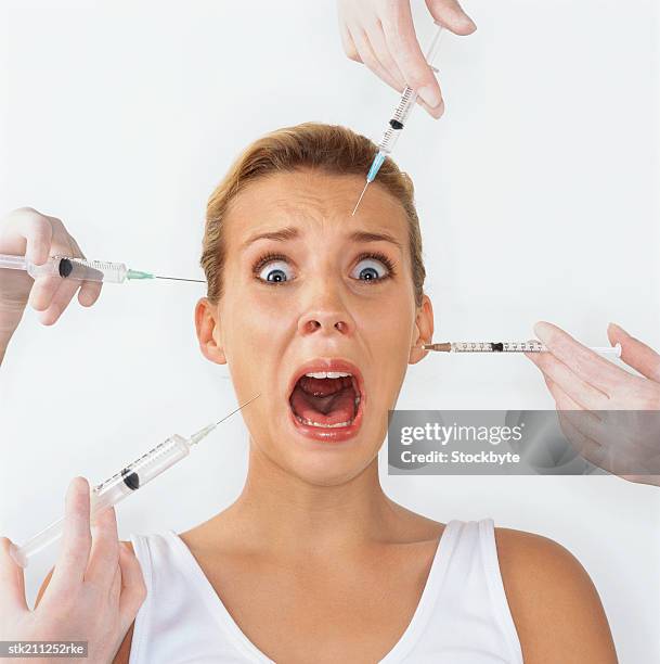 close up of a woman screaming while her face is injected - is stock pictures, royalty-free photos & images