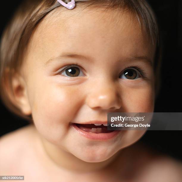 close up view of a baby girl (6-12 months) smiling - only baby girls stock pictures, royalty-free photos & images
