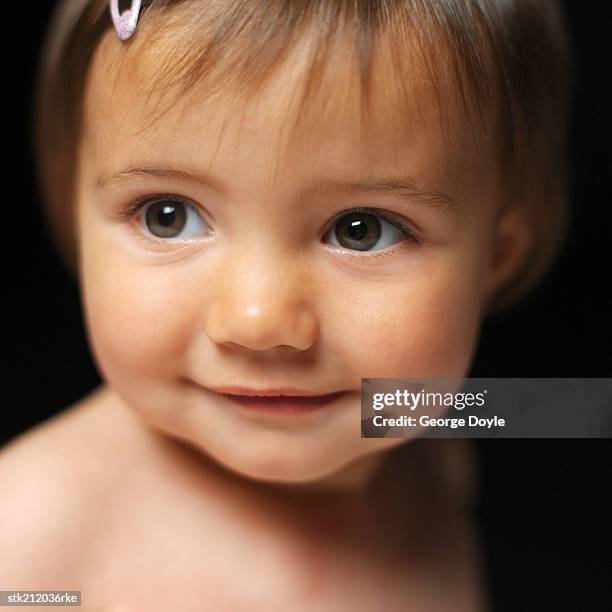 close up view of a baby girl (6-12 months) smiling - only baby girls stock pictures, royalty-free photos & images