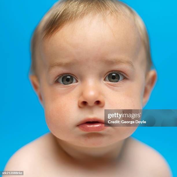 close up view of a baby girl (6-12 months) looking sad - only baby boys stock pictures, royalty-free photos & images