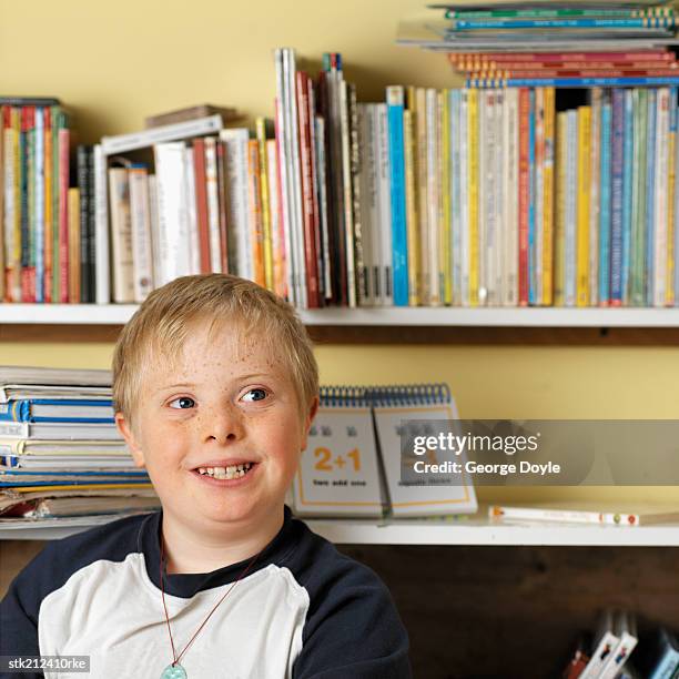portrait of a boy (7-10) with down syndrome in a classroom - donald trump holds campaign rally in nc one day ahead of primary stockfoto's en -beelden
