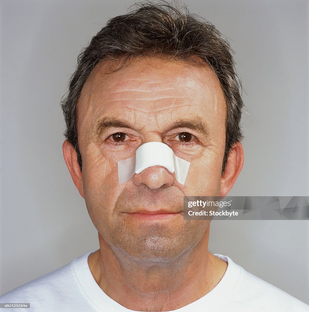 Portrait of a man with his nose bandaged