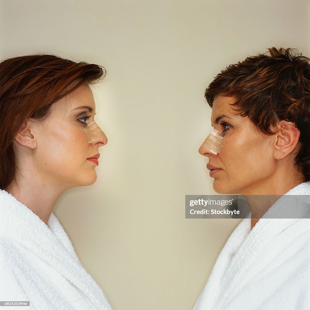 Side view of two women with bandaged noses