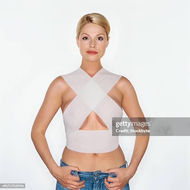 portrait of a woman wearing support bandages after breast surgery - after stock pictures, royalty-free photos & images
