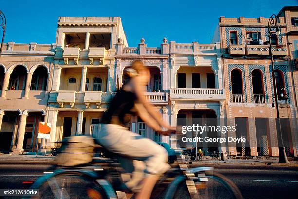 daytime view of malecon and person cycling - greater antilles stock-fotos und bilder