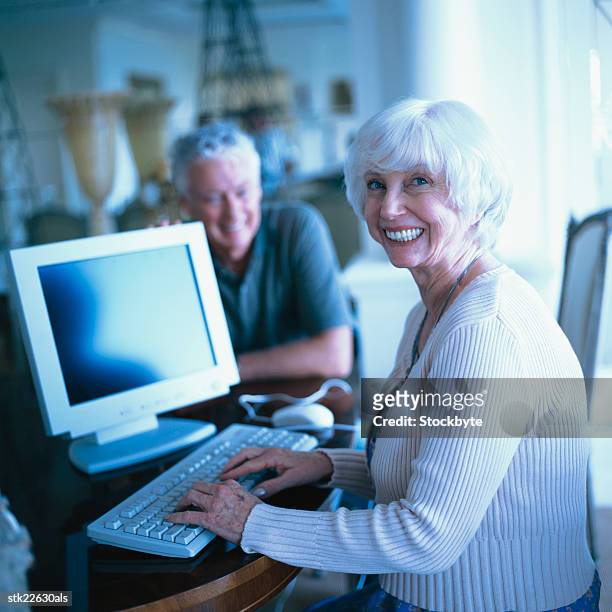 side profile of an elderly woman using a computer - silver surfer stock pictures, royalty-free photos & images