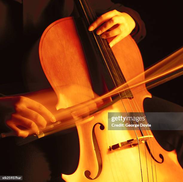 blurred shot of a person playing the cello - estilo musical imagens e fotografias de stock