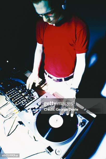 shot of a disc jockey on mixing decks - dj decks stock-fotos und bilder