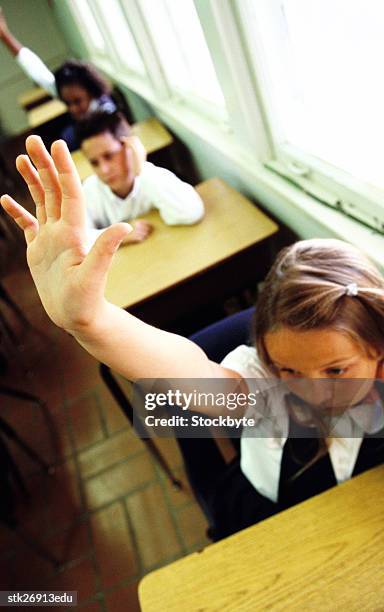 high angle view of a school girl (8-10) raising her arm to answer in class - donald trump holds campaign rally in nc one day ahead of primary stockfoto's en -beelden