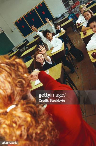 view from behind a teacher asking questions in class - donald trump holds campaign rally in nc one day ahead of primary stockfoto's en -beelden