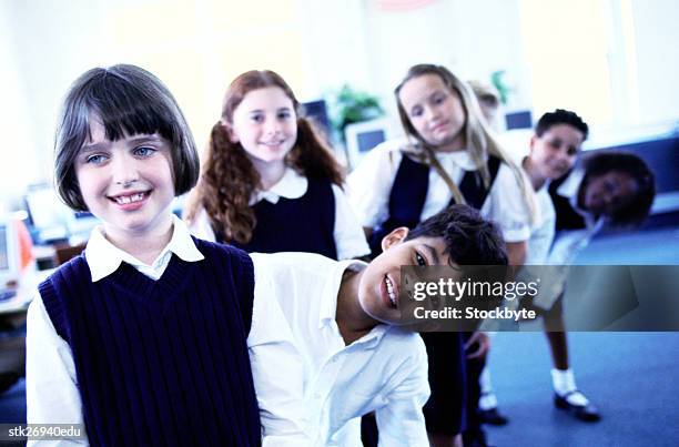 portrait of boys and girls (8-10) standing in single file in class - donald trump holds campaign rally in nc one day ahead of primary stockfoto's en -beelden