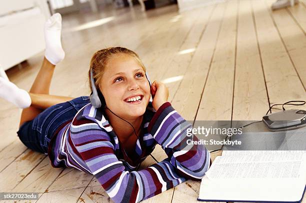 portrait of a girl (8-10) lying on the floor listening to music - donald trump holds campaign rally in nc one day ahead of primary stockfoto's en -beelden