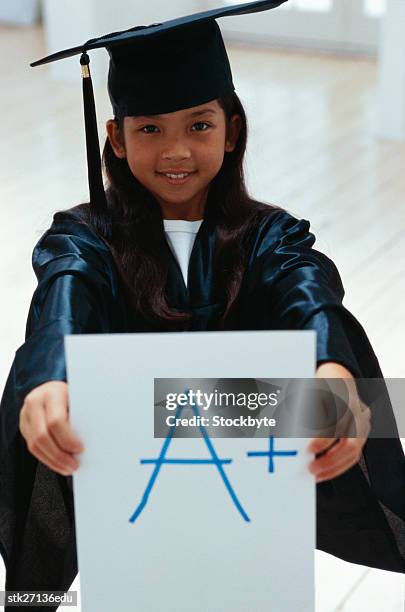 portrait of a girl (10-12 years) holding up grade on a card - donald trump holds campaign rally in nc one day ahead of primary stockfoto's en -beelden