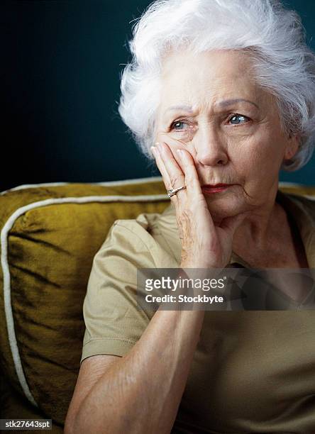 portrait of an elderly woman in a state of worry - anciano llorando fotografías e imágenes de stock