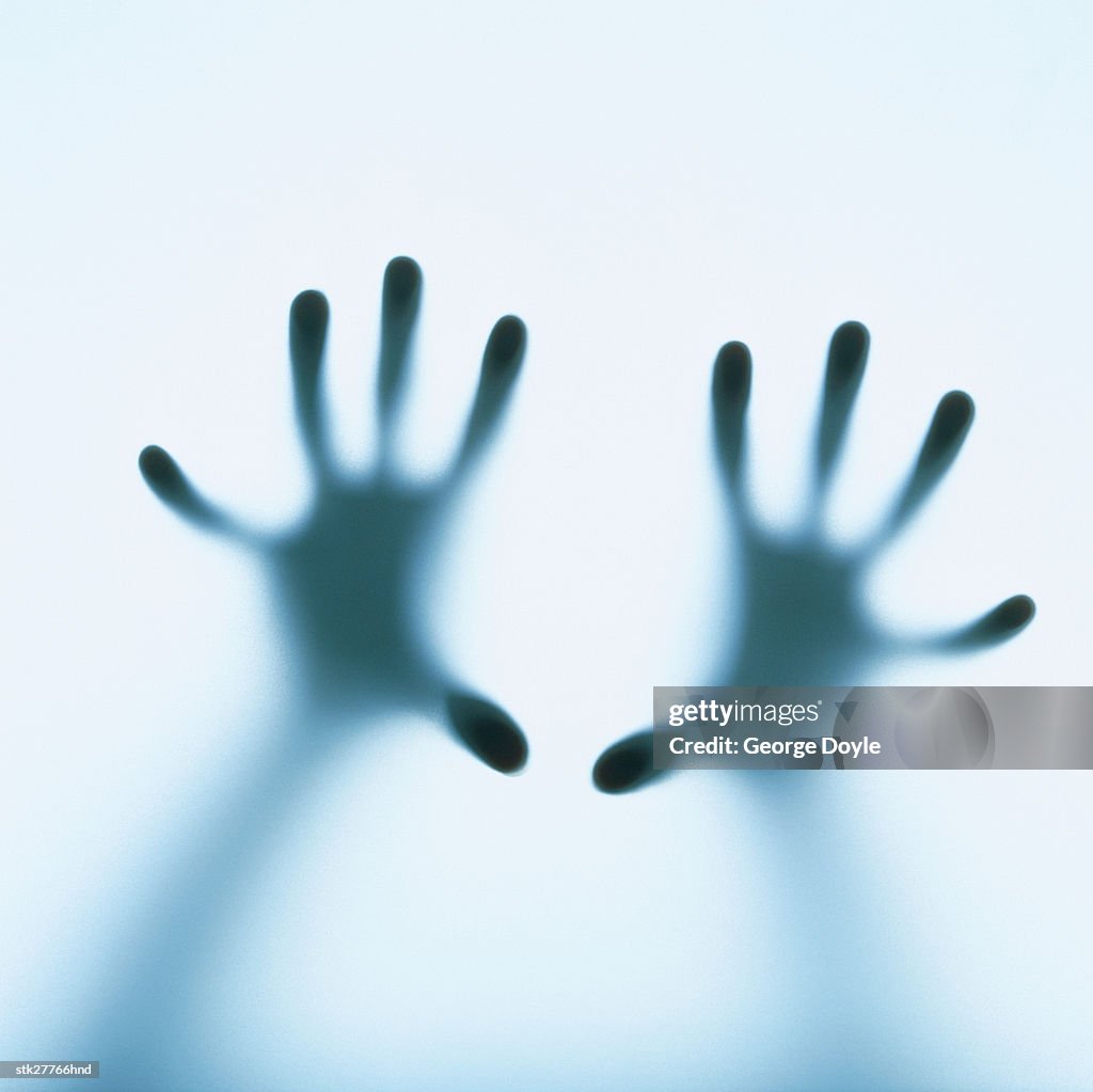 Close-up of human hands resting on a screen