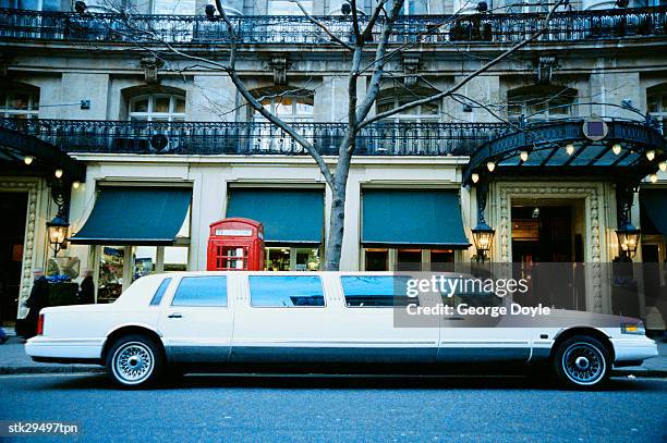 side view of a limousine parked outside a hotel - limousine stock pictures, royalty-free photos & images