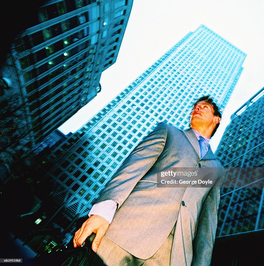 Low angle view of a businessman standing outdoors; blurred