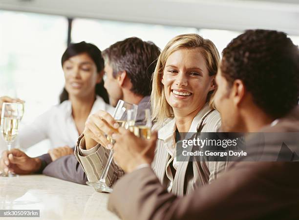 four people sitting together at a bar counter - bar ストックフォトと画像
