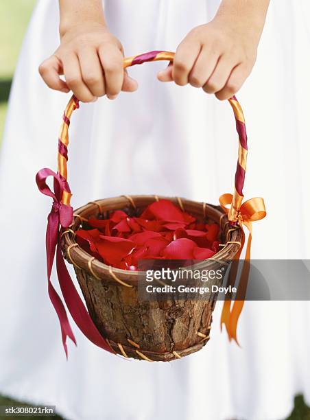 low section view of a bridesmaid holding a basket of flowers - rosaceae stock pictures, royalty-free photos & images