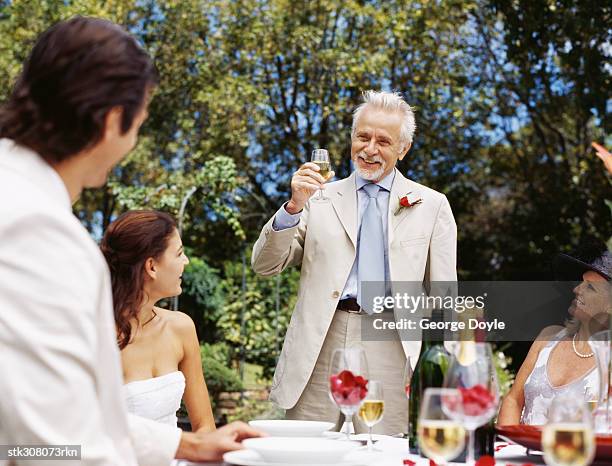 mature man raising a toast at a wedding reception - rosaceae stock pictures, royalty-free photos & images