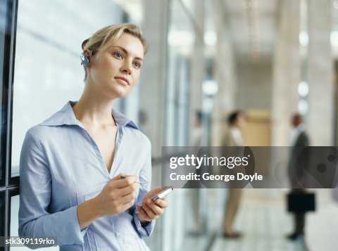 Personal Data Assistant Example Businesswoman Using A Personal Data Assistant In An Office High-Res ...