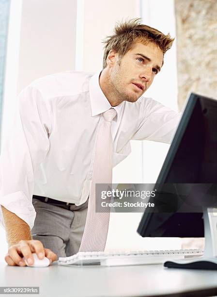 close-up of a businessman using a computer in an office - ojos grises fotografías e imágenes de stock
