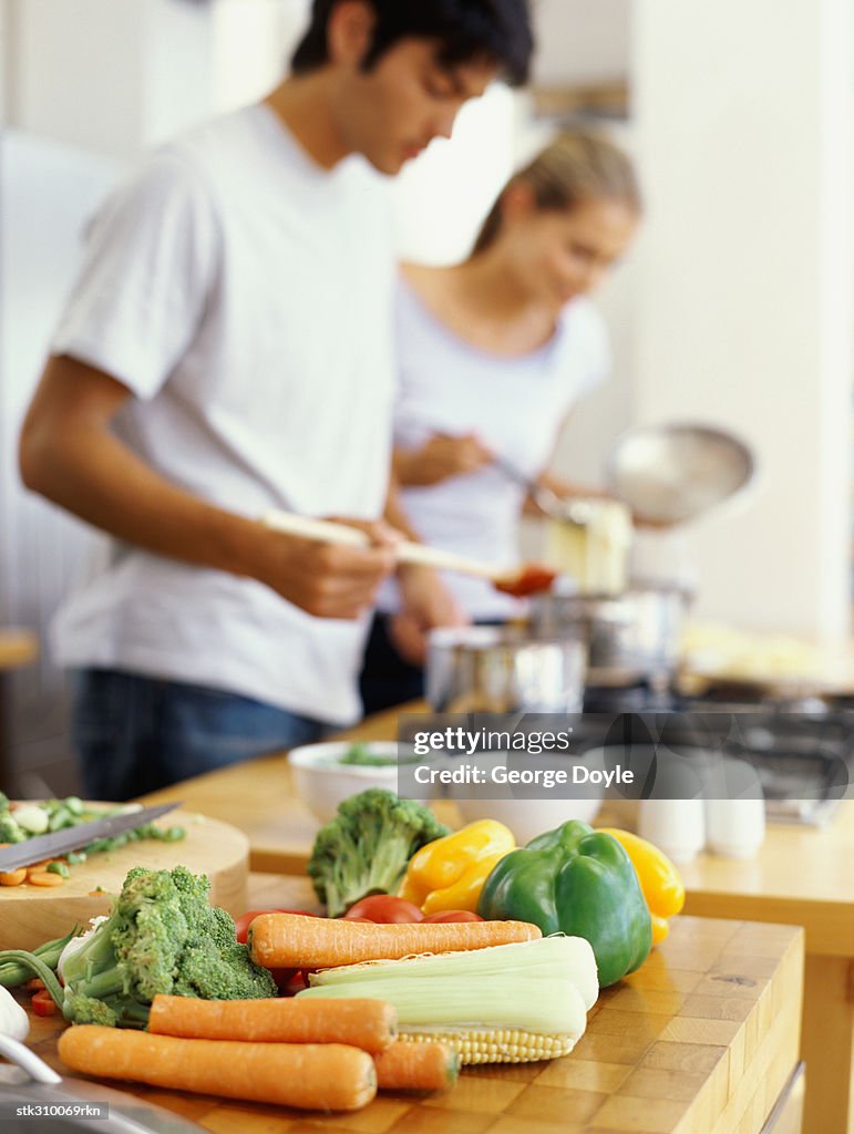 Side profile of a young couple cooking food in the kitchen