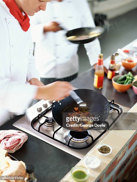 high angle view of two chefs cooking food in the kitchen - the kitchen bildbanksfoton och bilder