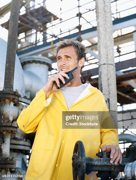 mechanic talking on a walkie-talkie - transceiver stock pictures, royalty-free photos & images