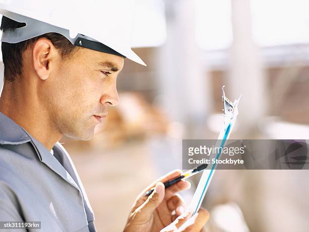 close-up of a construction worker wearing a hardhat at a construction site - inside the link real estate investment trust properties ahead of interim results stockfoto's en -beelden