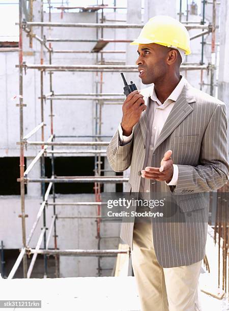 male architect holding a walkie-talkie - transceiver stock pictures, royalty-free photos & images