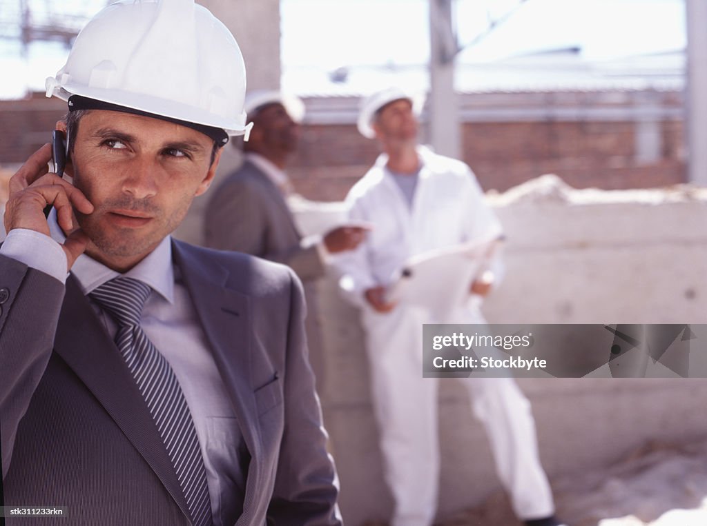 Close-up of an architect talking on a mobile phone at a construction site