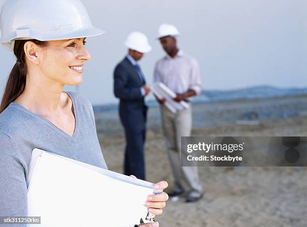 close-up of a female architect holding a clipboard at a construction site - inside the link real estate investment trust properties ahead of interim results stockfoto's en -beelden