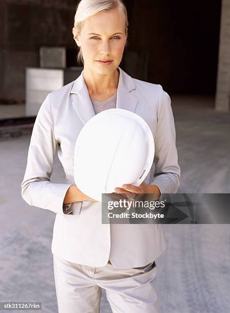 portrait of a female architect holding a blueprint - ontwerp beroep stockfoto's en -beelden