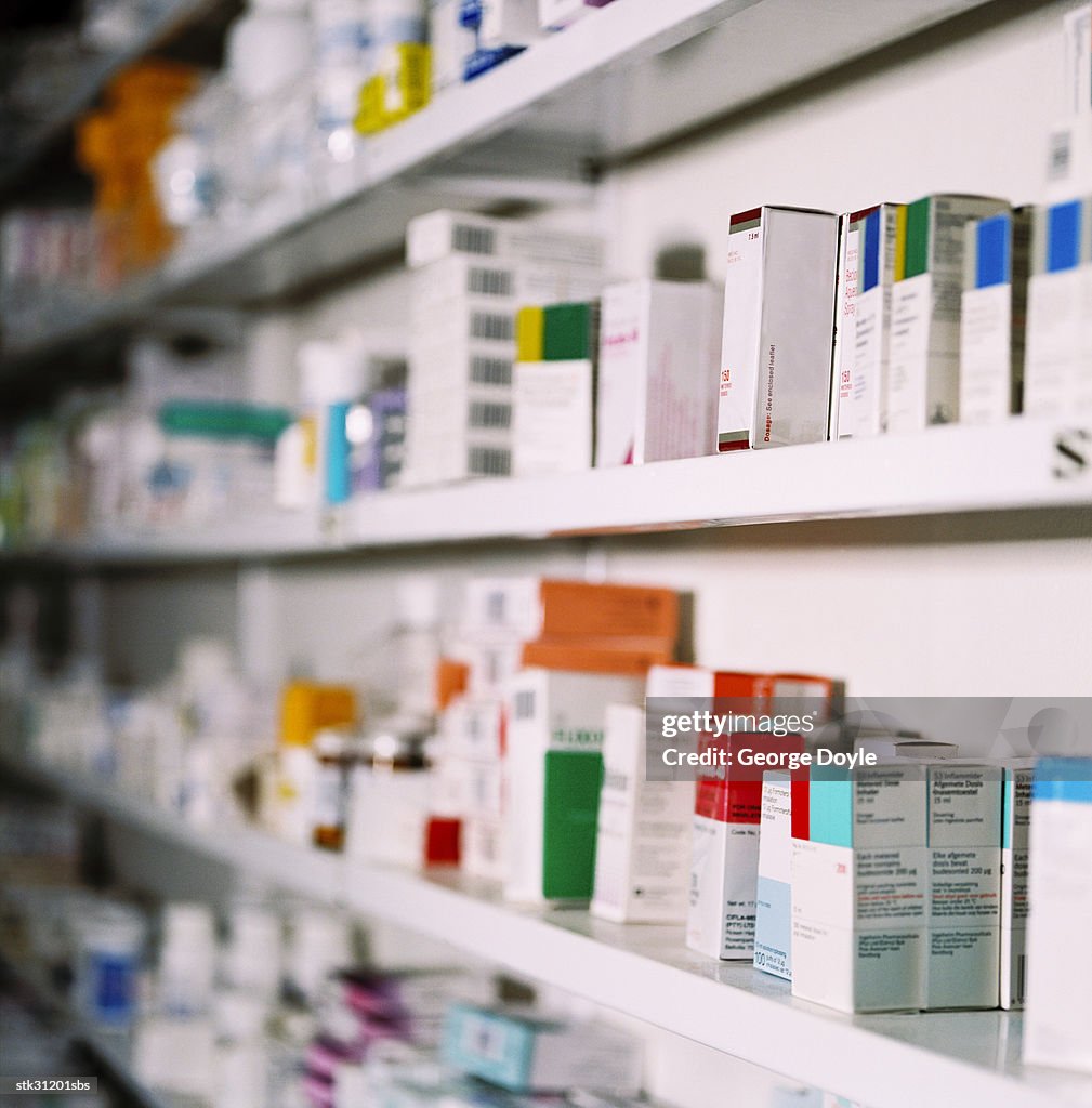 Side view of rows of medicines on a shelf