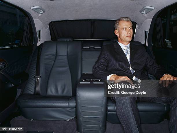 businessman sitting in a car - hand on knee stock pictures, royalty-free photos & images