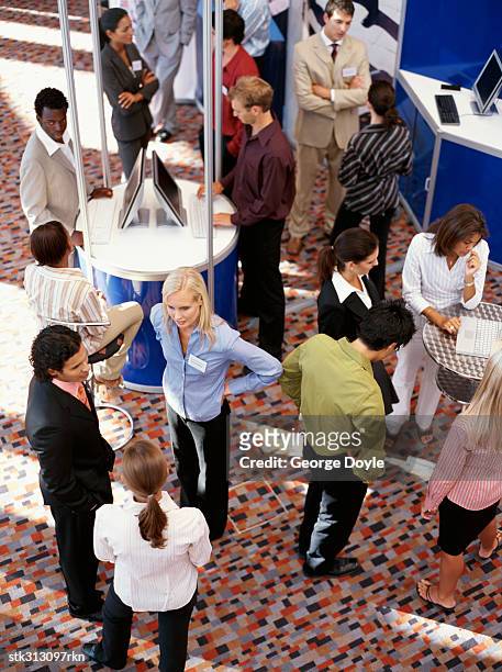 high angle view of a group of business executives at an exhibition - exhibition foto e immagini stock