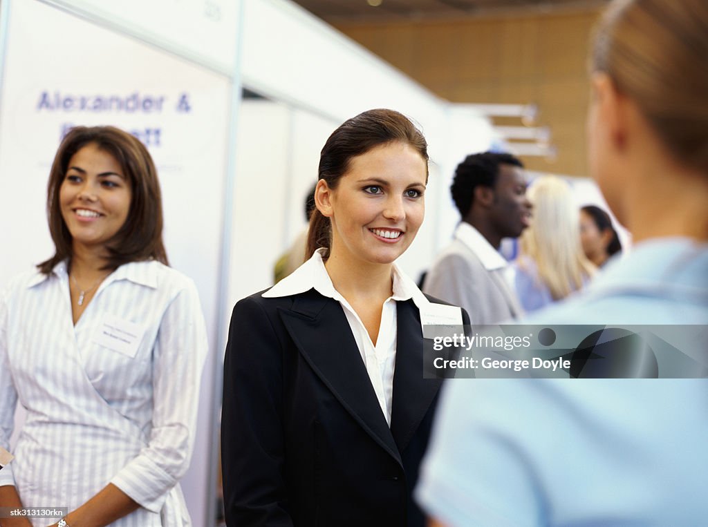 Three businesswomen at an exhibition