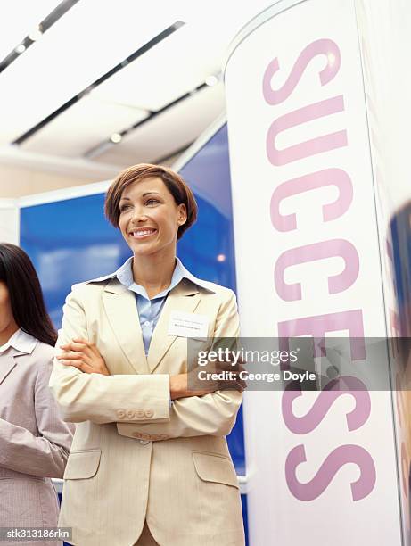 businesswoman standing with her arms crossed at an exhibition - king juan carlos and queen sofia attends 25th anniversary tribute of seville universal exhibition stockfoto's en -beelden