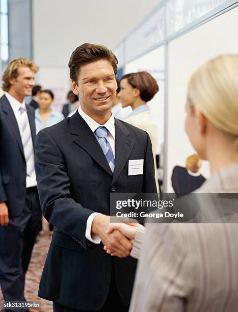 businessman shaking hands with a businessman at an exhibition - king juan carlos and queen sofia attends 25th anniversary tribute of seville universal exhibition stockfoto's en -beelden