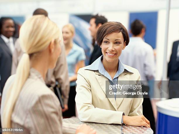 two businesswomen talking to each other at an exhibition - king juan carlos and queen sofia attends 25th anniversary tribute of seville universal exhibition stockfoto's en -beelden