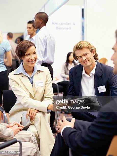 business executives discussing at an exhibition - hand on knee stock pictures, royalty-free photos & images