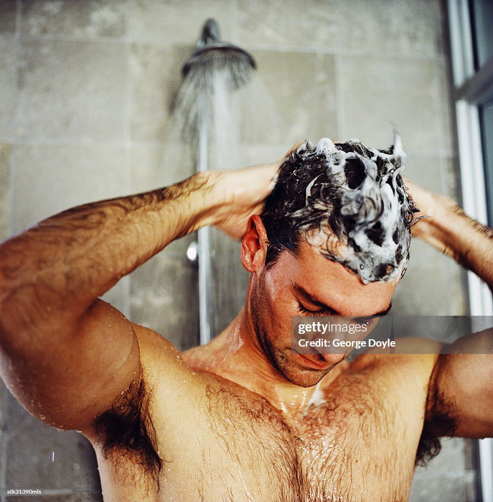 Close-up of a man washing his hair in the shower