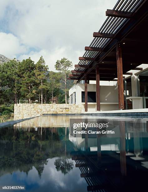 reflection of a house in a  swimming pool - reflection foto e immagini stock